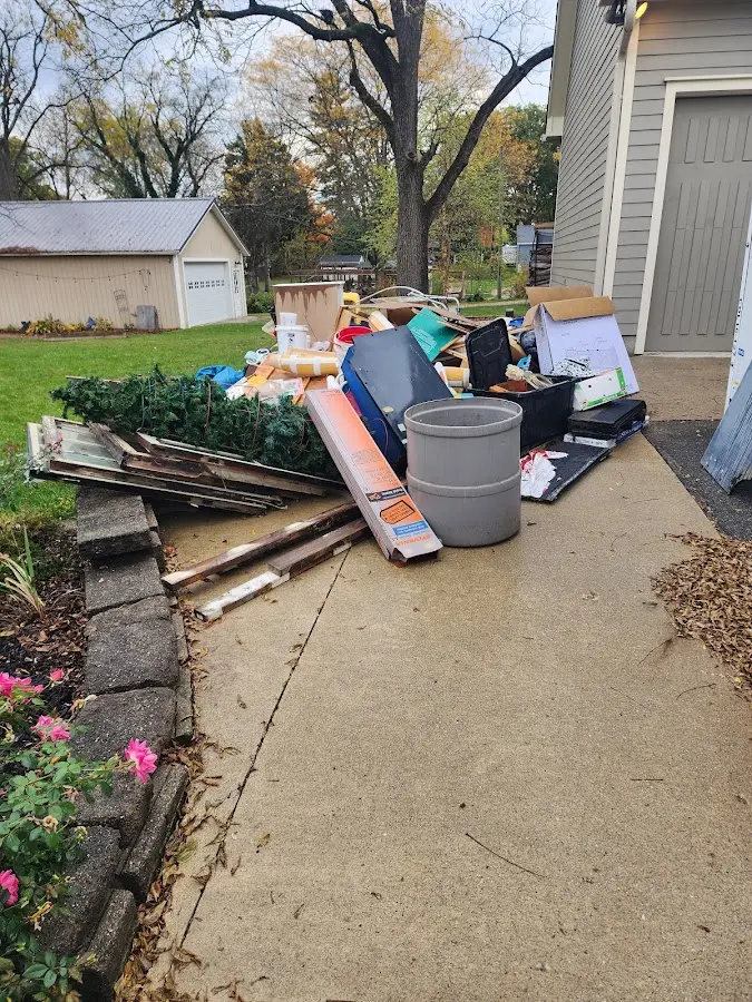 Dumpster being loaded with debris for Estate Cleanout Dumpster Rental in Cambria